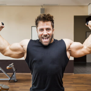a strong muscular man flexes his arms